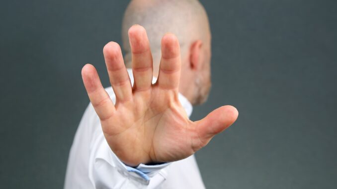 man-negative-hand-gesture-and-turned-away-min