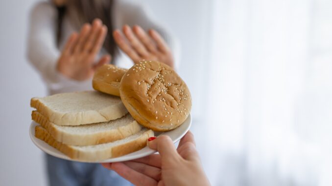 young-woman-suffers-from-gluten-min